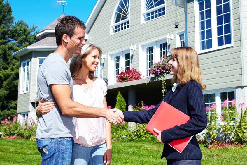 real estate agent with happy couple